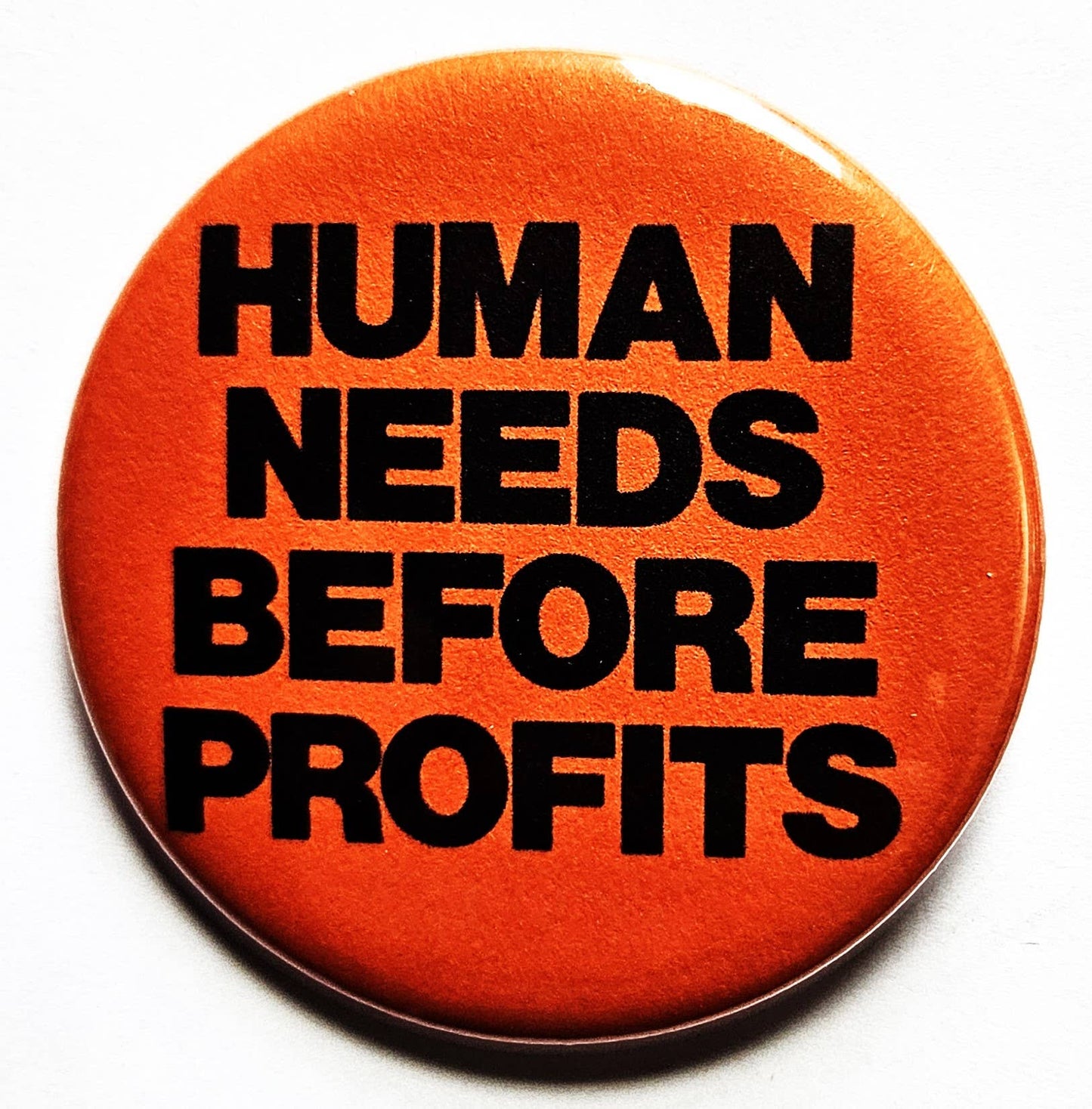 Human Needs Before Profits Button