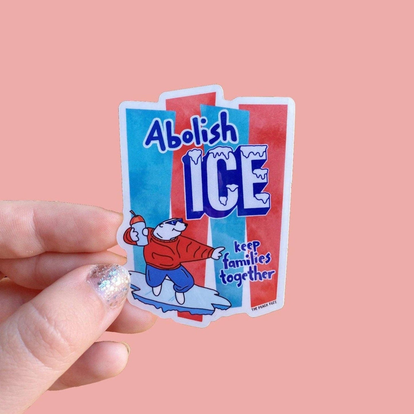 Sticker with 'Abolish ICE' text held by a hand on a pink background